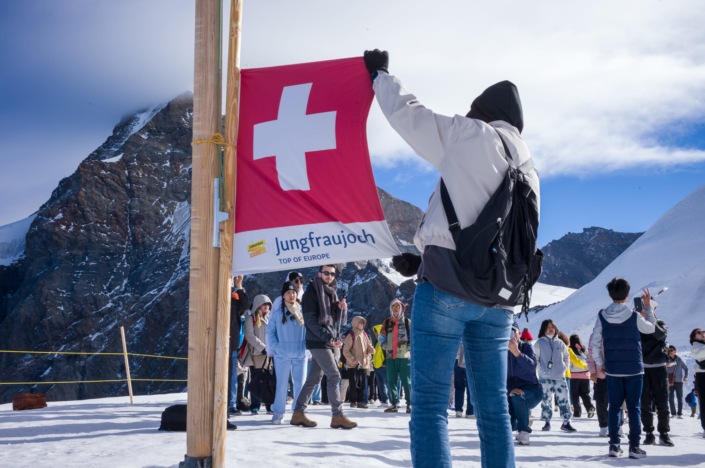 Suisse, Jungfraujoch. Tourisme de masse et drapeau suisse