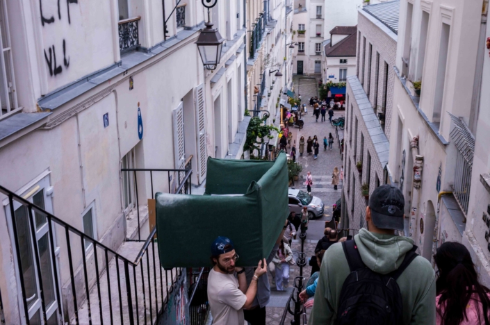 Deux Parisien portent un canapé dans les escaliers de Montmartre - Photographie